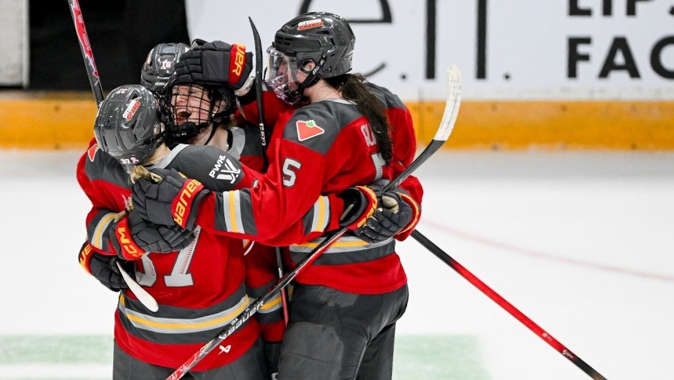 Players for the Ottawa Charge hug after a win.